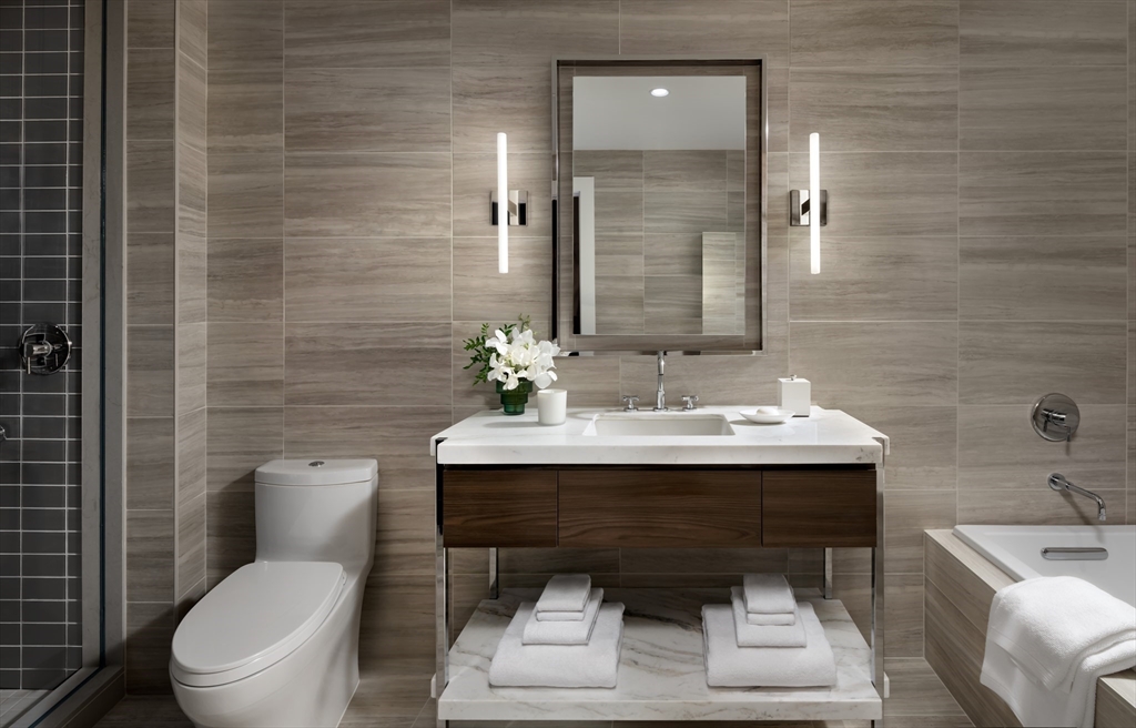 40 Trinity Place, Unit 1508 Boston, MA 02116 - Photo 2 of 30 a bathroom with a toilet a sink and mirror