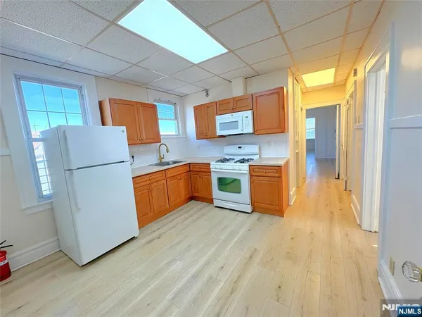 a kitchen with stainless steel appliances granite countertop a refrigerator a stove a sink dishwasher and a refrigerator