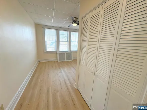 a view of a room with wooden floor and a window