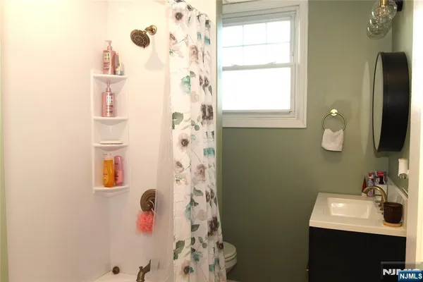 a bathroom with a sink a mirror and a shower
