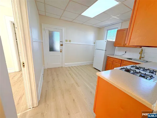 a kitchen with a sink stove and refrigerator