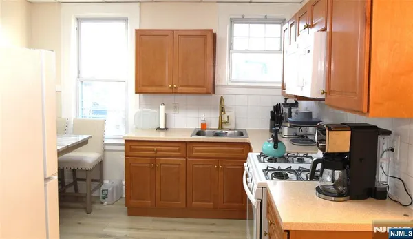 a kitchen with a sink cabinets and window