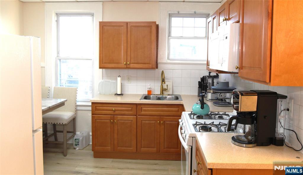 28 Rutland Avenue, Unit 3 Kearny, NJ 07032 - Photo 10 of 13 a kitchen with a sink cabinets and window