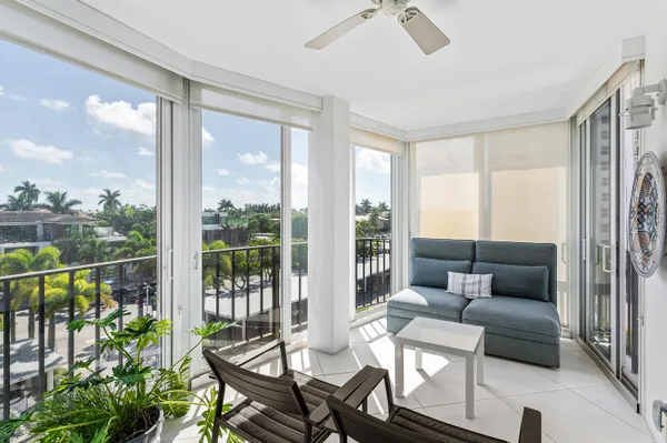 a living room with furniture and a floor to ceiling window