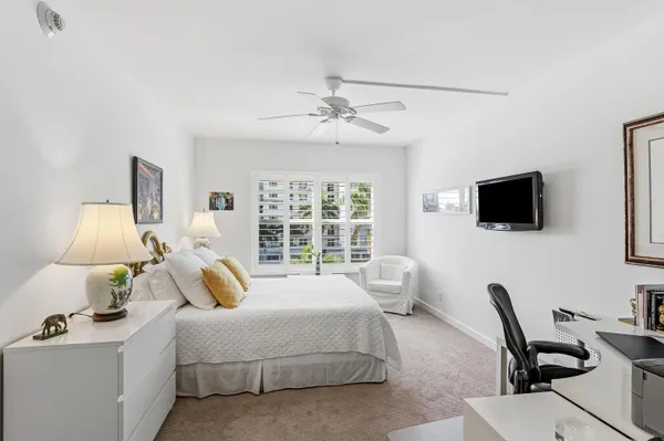 a bed room with bed and a flat screen tv