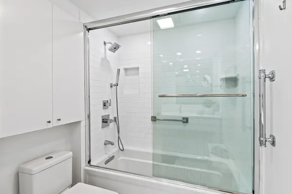 a bathroom with a shower and a mirror
