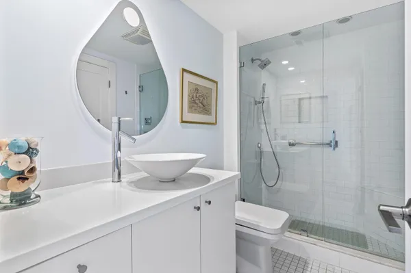 a bathroom with a sink a toilet and shower
