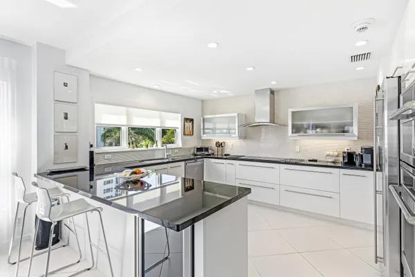 a kitchen with stainless steel appliances granite countertop a sink and cabinets