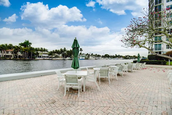 a view of a lake with table and chairs