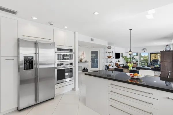 a kitchen with refrigerator a sink and cabinets