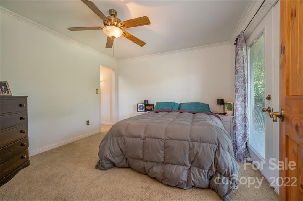 138 Robertson Creek Church Road Bostic, NC 28018 - Photo 13 of 31 a bedroom with a bed and a ceiling fan