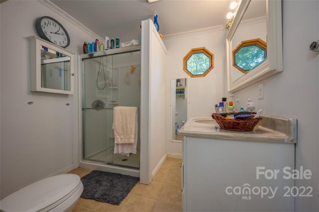 138 Robertson Creek Church Road Bostic, NC 28018 - Photo 15 of 31 a bathroom with a toilet a sink and a shower