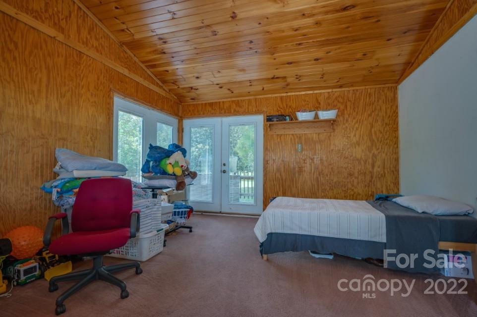 138 Robertson Creek Church Road Bostic, NC 28018 - Photo 18 of 31 a bedroom with a bed a chair and the potted plant