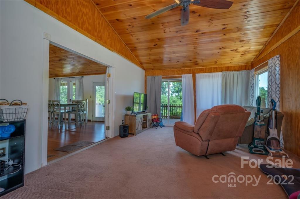138 Robertson Creek Church Road Bostic, NC 28018 - Photo 19 of 31 a living room with furniture a ceiling fan and a large window