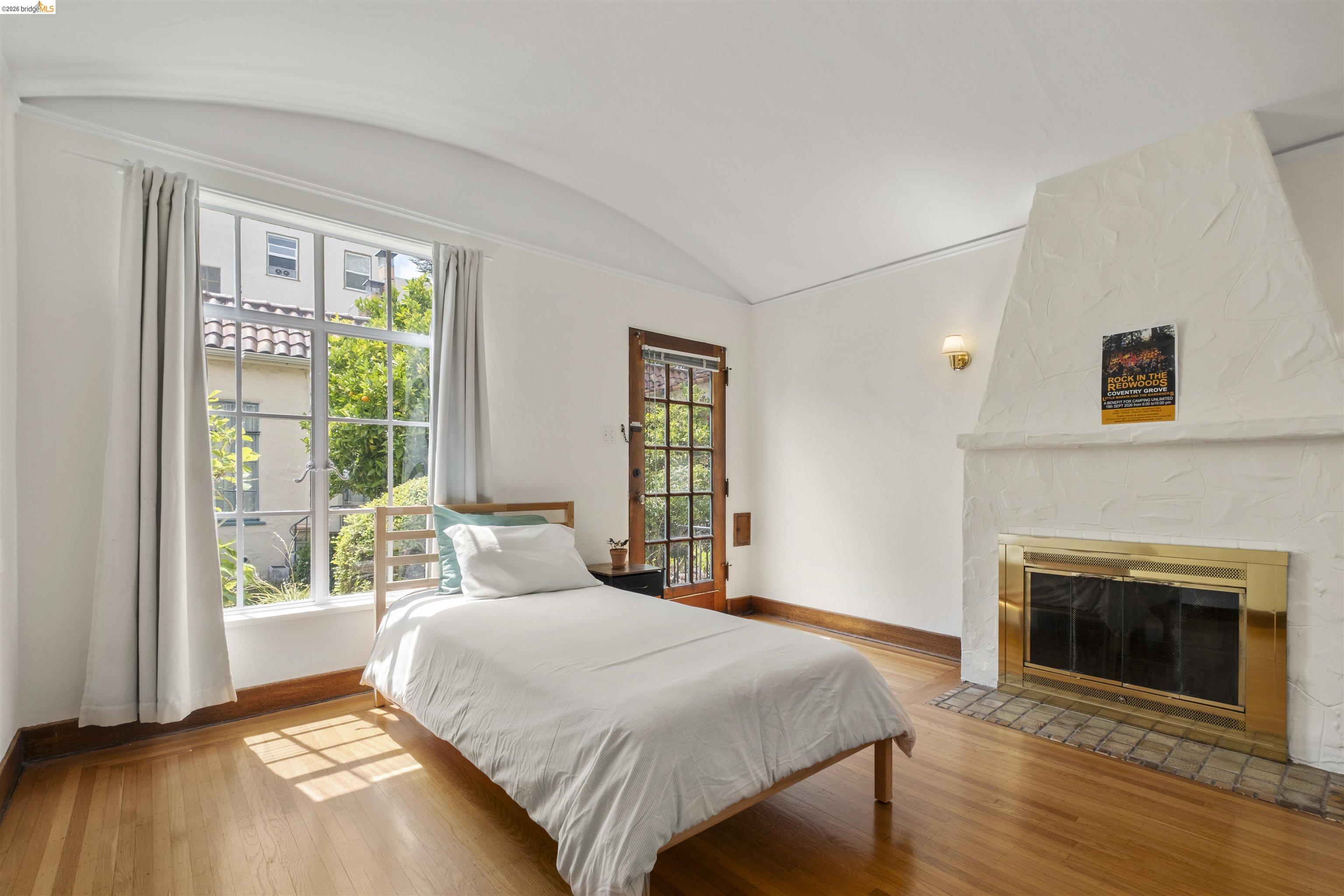 2444 Virginia Street, Unit B Berkeley, CA 94709 - Photo 31 of 39 Hardwood flooring throughout featuring a decorative white fireplace with a brass firebox