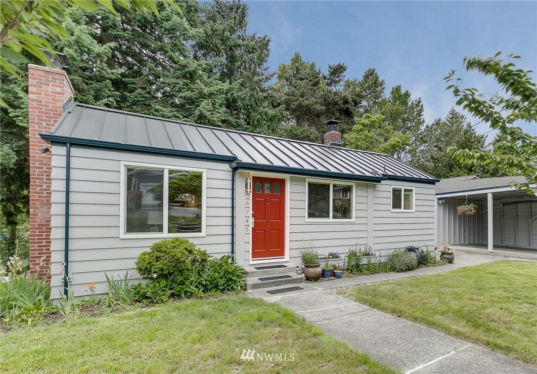 a front view of a house with yard and green space