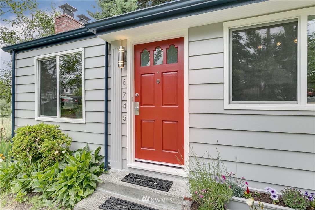 6745 18th Avenue Southwest Seattle, WA 98106 - Photo 2 of 24 a front view of a house with a yard