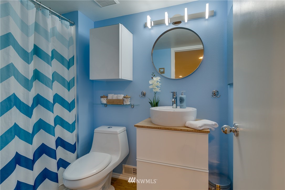 6745 18th Avenue Southwest Seattle, WA 98106 - Photo 17 of 24 a bathroom with a sink mirror toilet and shower
