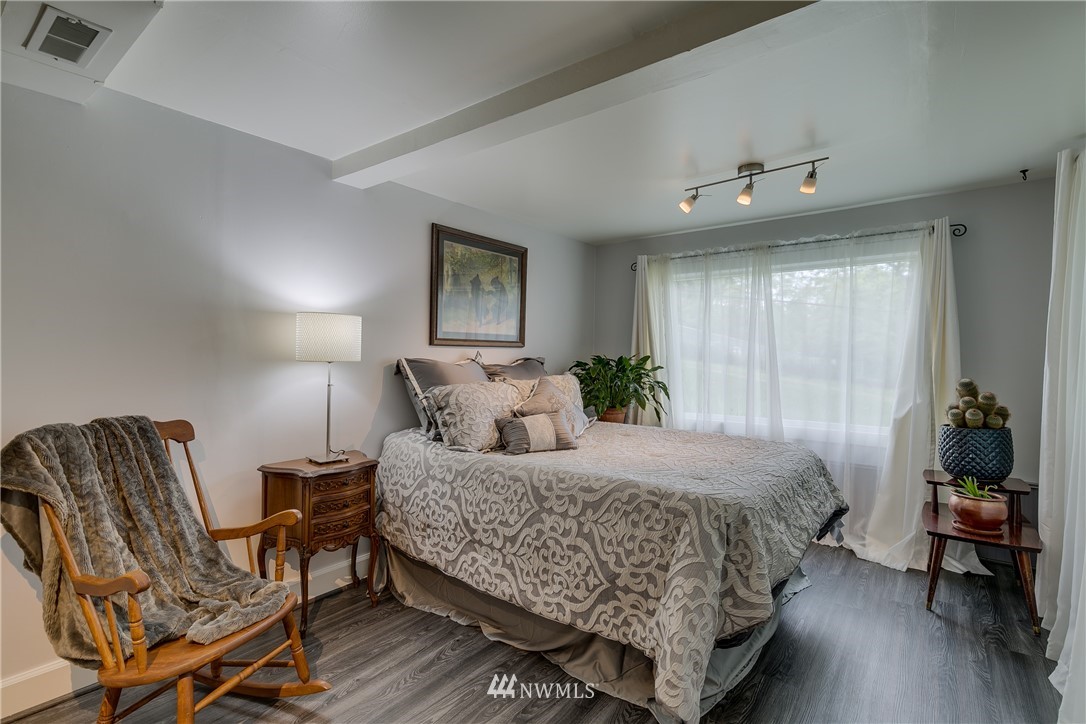 6745 18th Avenue Southwest Seattle, WA 98106 - Photo 18 of 24 a bedroom with a bed and furniture