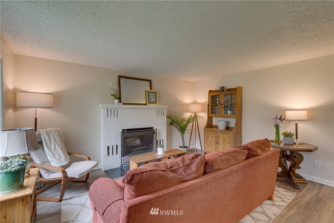 6745 18th Avenue Southwest Seattle, WA 98106 - Photo 4 of 24 a living room with furniture and a fireplace