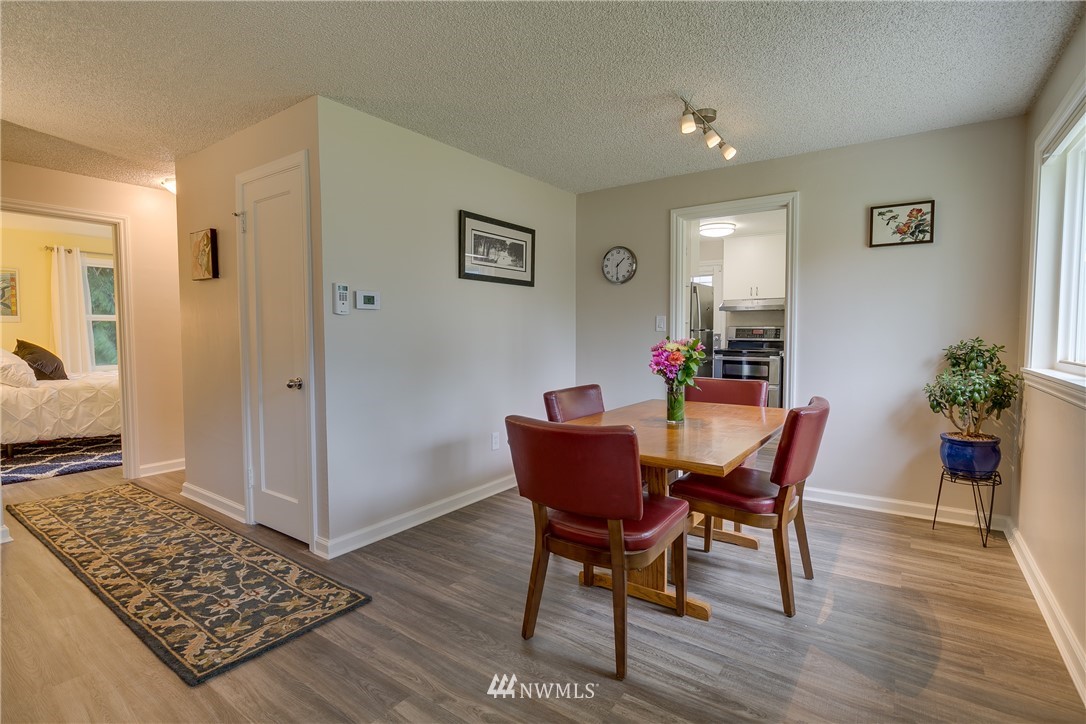 6745 18th Avenue Southwest Seattle, WA 98106 - Photo 6 of 24 a view of a dining room with furniture and wooden floor