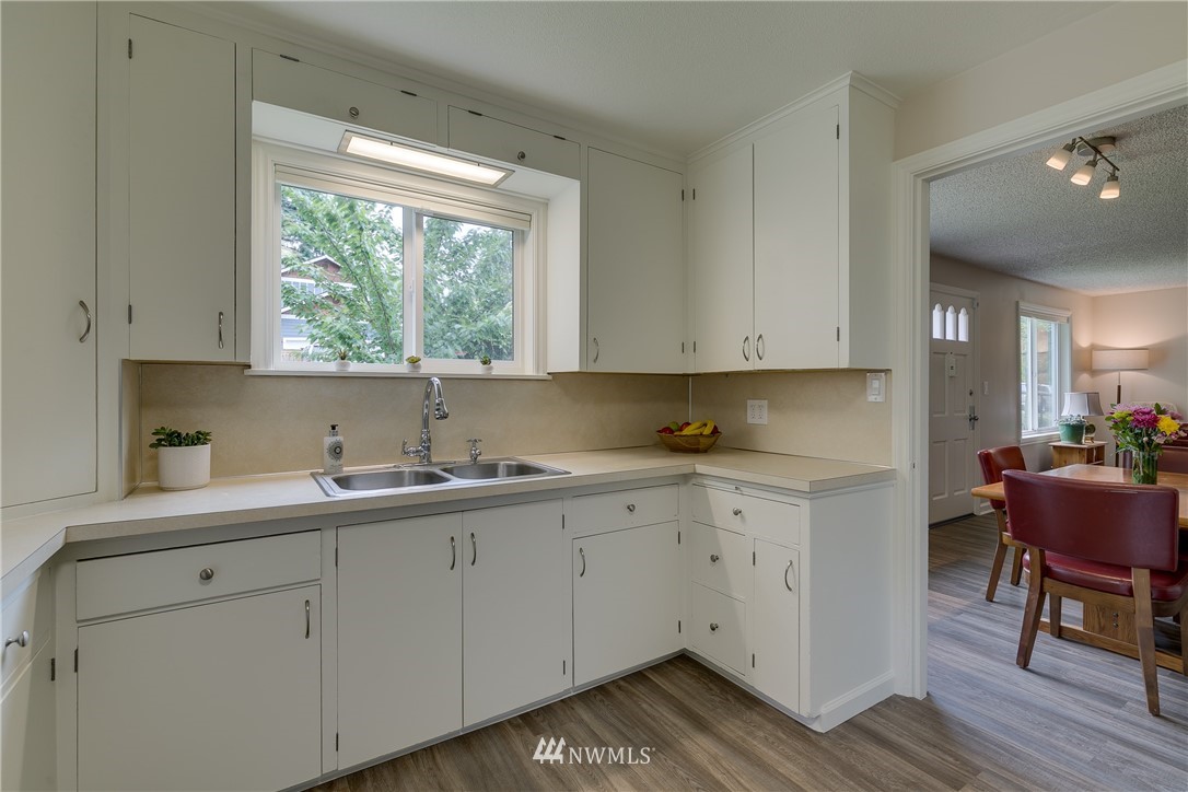 6745 18th Avenue Southwest Seattle, WA 98106 - Photo 9 of 24 a kitchen with a sink window and cabinets