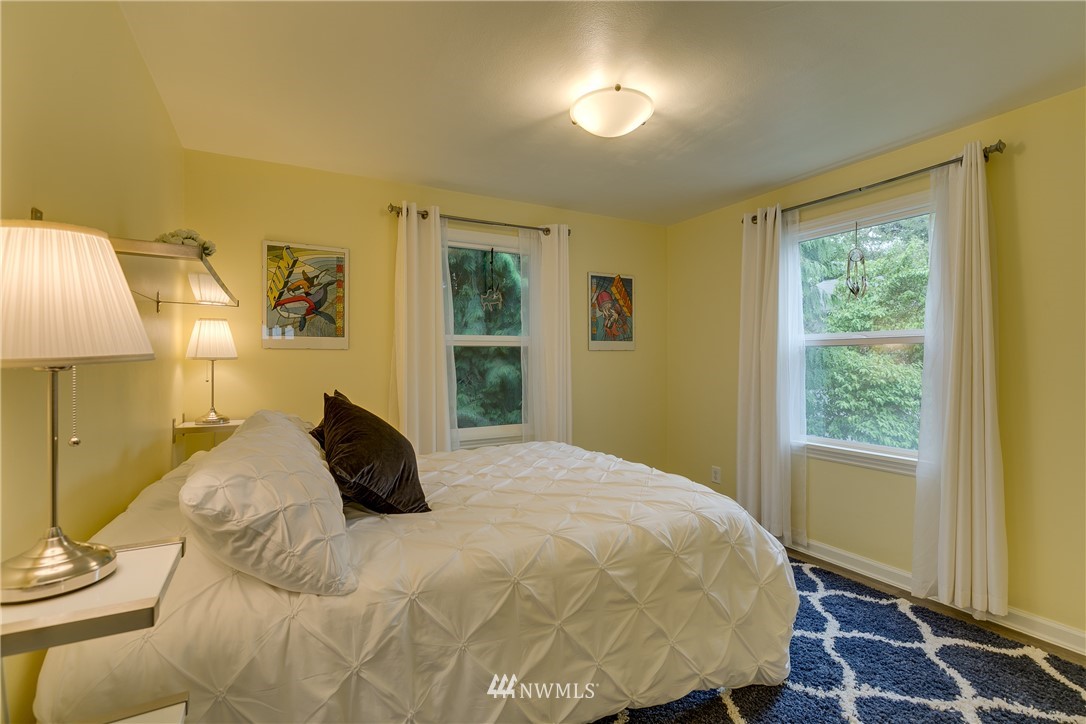6745 18th Avenue Southwest Seattle, WA 98106 - Photo 10 of 24 a bedroom with a bed and a window
