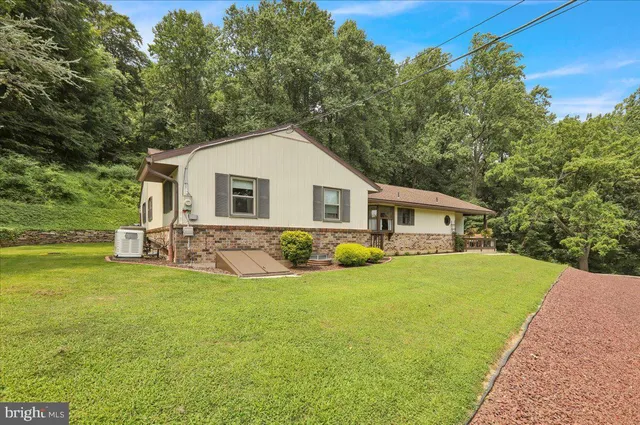 a front view of house with yard and green space