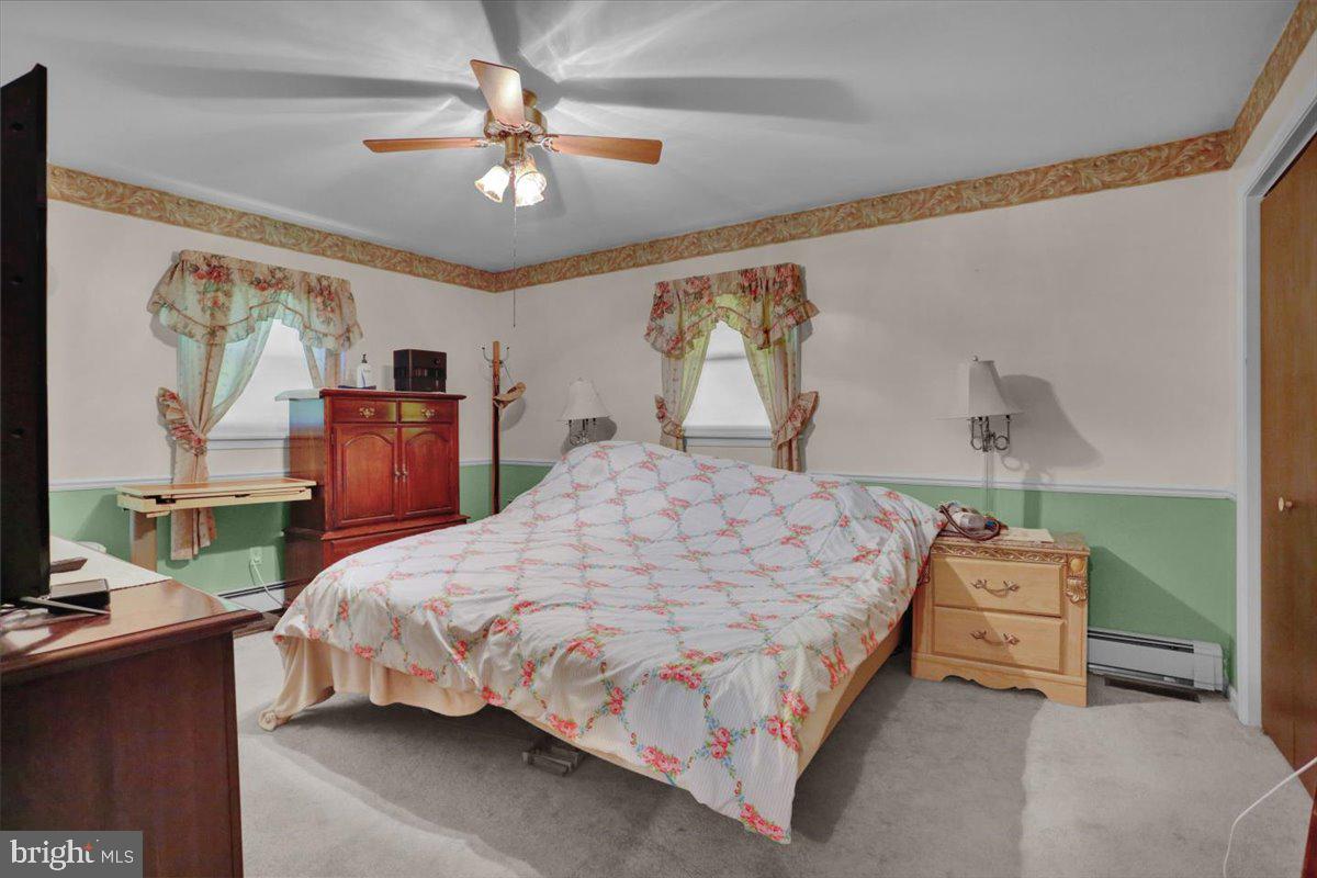 90 Preston Road Wernersville, PA 19565 - Photo 28 of 45 a bedroom with a bed and a chandelier