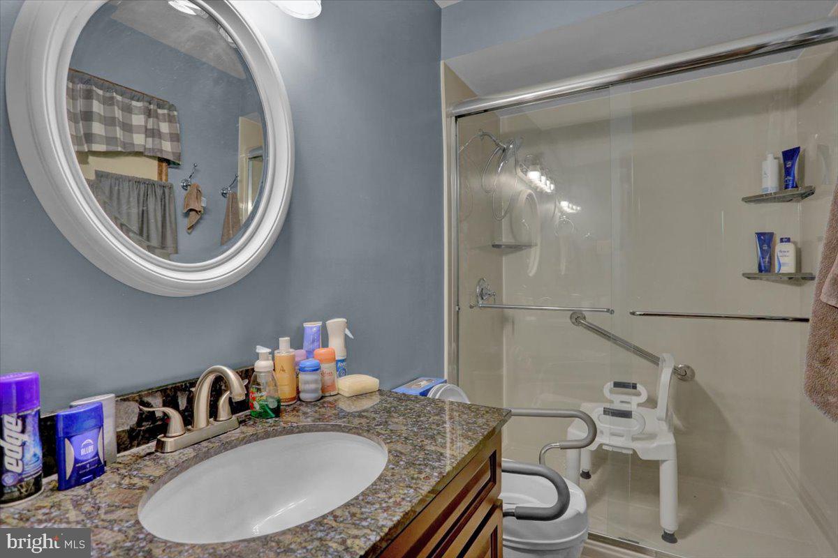 90 Preston Road Wernersville, PA 19565 - Photo 30 of 45 a bathroom with a granite countertop toilet a sink and a mirror