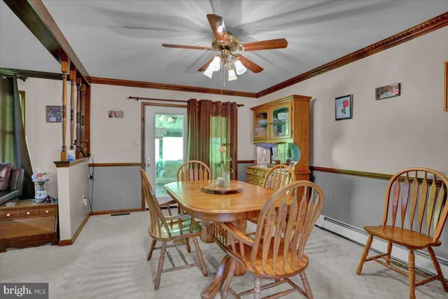 a view of a dining room with furniture and a chandelier
