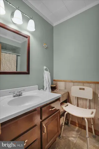 a bathroom with a sink a toilet and mirror