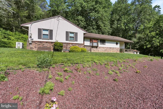 a aerial view of a house with a yard table and chairs