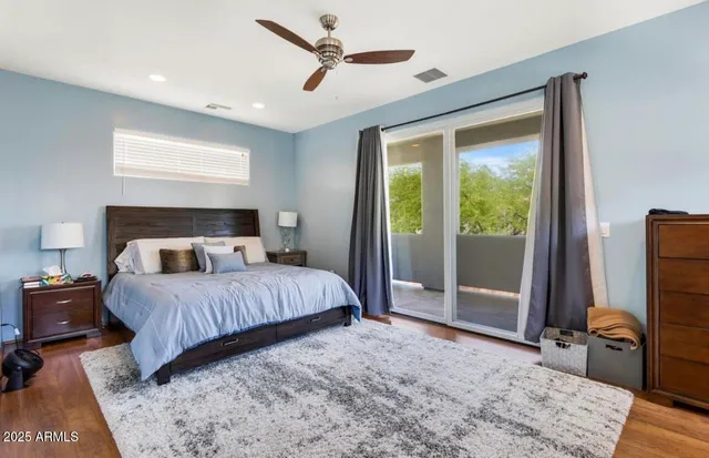 a bedroom with a large bed and a flat tv screen