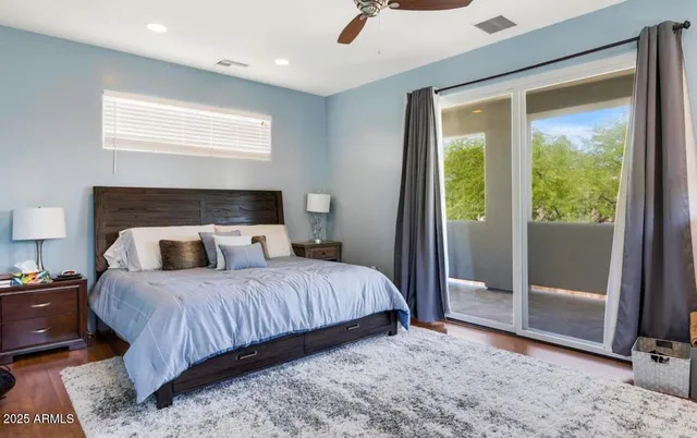 a bedroom with a bed and large window