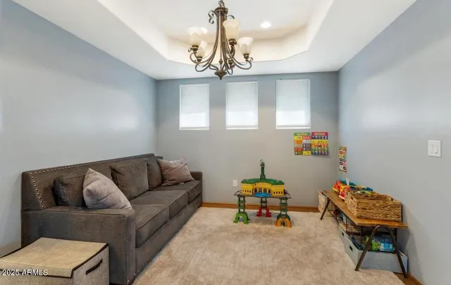 a living room with furniture a chandelier and a chandelier