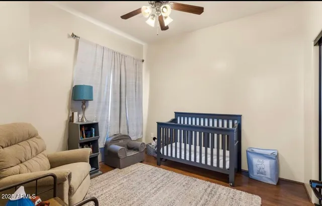 a bedroom with furniture and wooden floor
