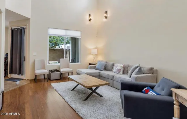 a living room with furniture and a potted plant