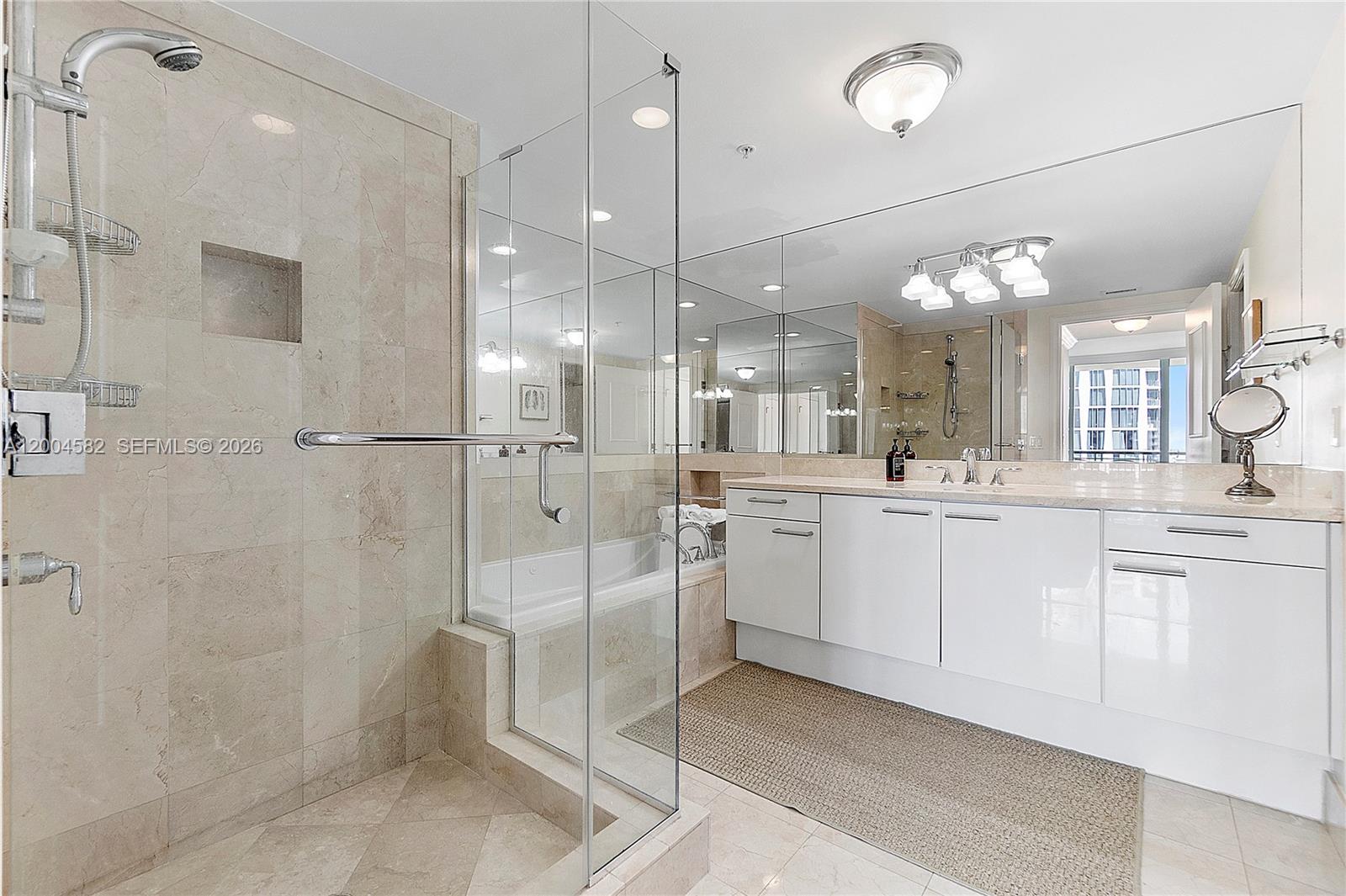 3350 Southwest 27th Avenue, Unit 1803 Miami, FL 33133 - Photo 13 of 22 a large white bathroom with a double vanity sink mirror and shower