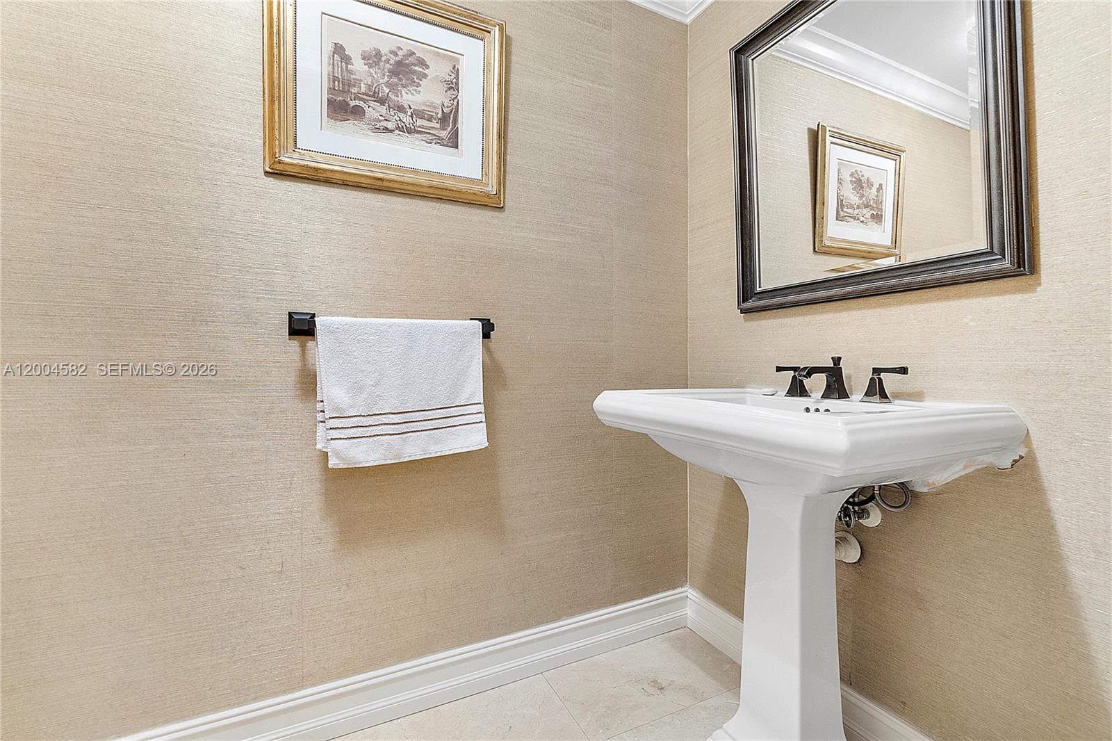 3350 Southwest 27th Avenue, Unit 1803 Miami, FL 33133 - Photo 16 of 22 a bathroom with a sink and a mirror