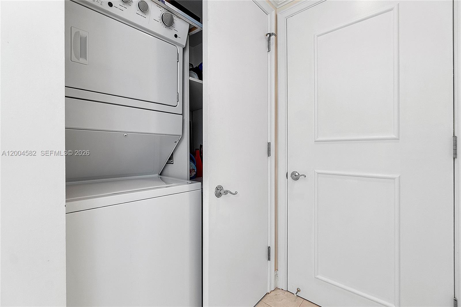 3350 Southwest 27th Avenue, Unit 1803 Miami, FL 33133 - Photo 17 of 22 a white refrigerator freezer and a dishwasher with wooden floor