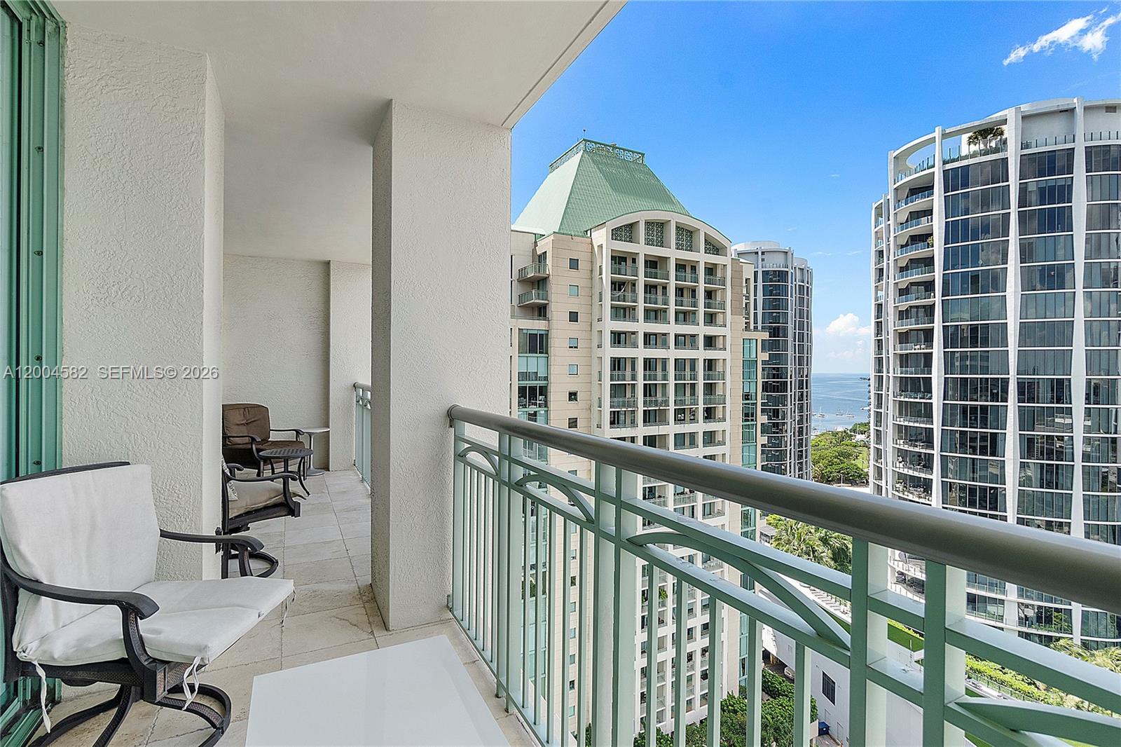 3350 Southwest 27th Avenue, Unit 1803 Miami, FL 33133 - Photo 19 of 22 a view of balcony with a couple of chairs and a potted plant