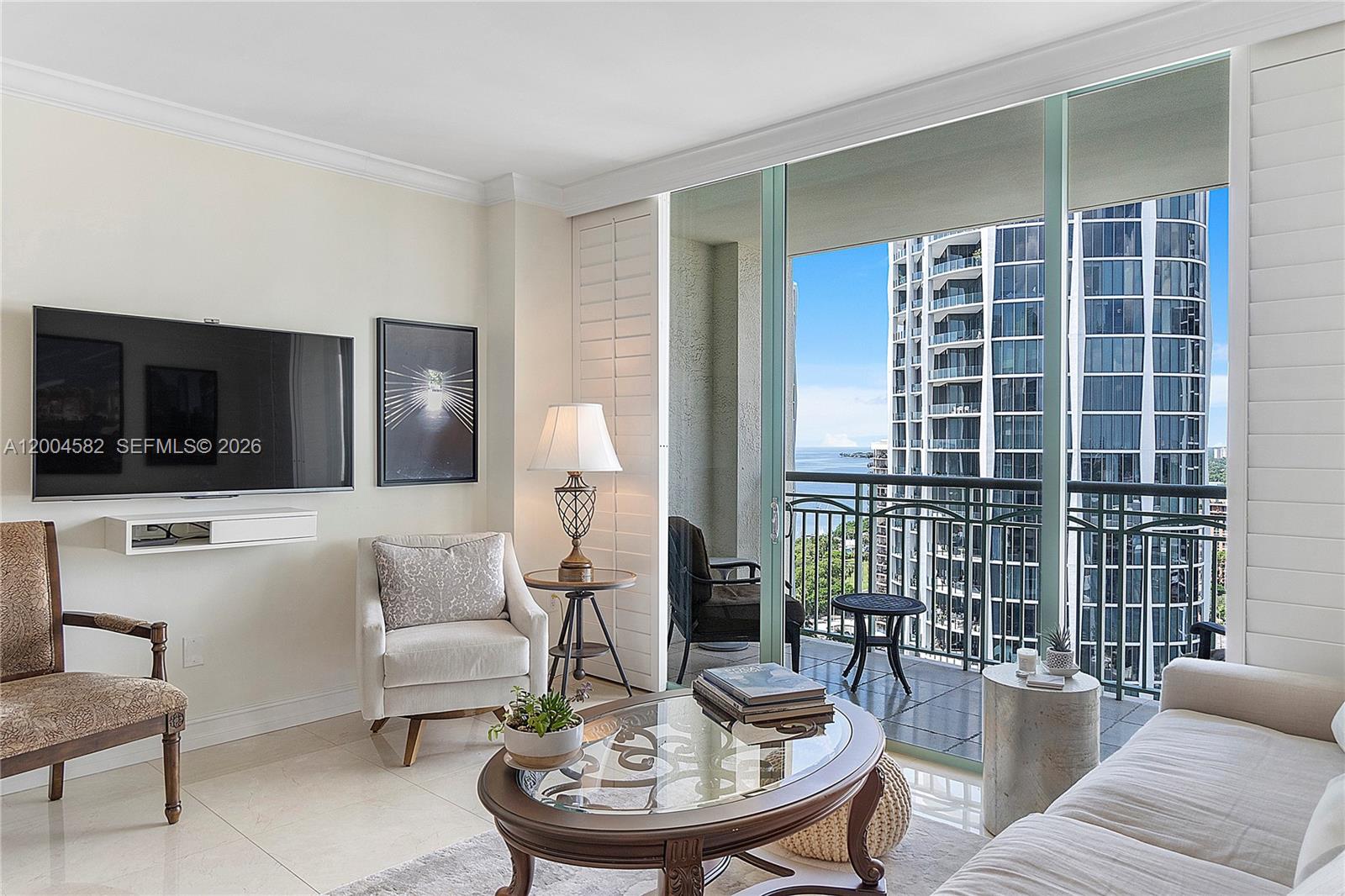3350 Southwest 27th Avenue, Unit 1803 Miami, FL 33133 - Photo 10 of 22 a living room with furniture and a flat screen tv