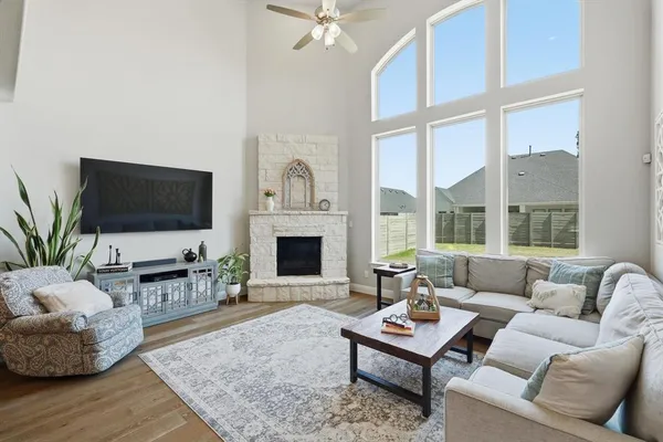 a living room with furniture a flat screen tv and a fireplace