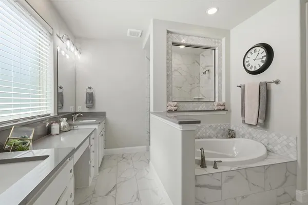 a bathroom with a granite countertop sink mirror and vanity
