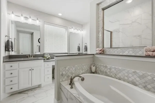 a bathroom with a bathtub and a sink