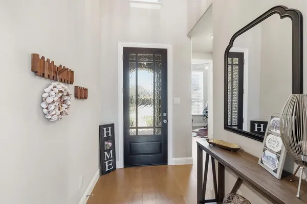 a view of a hallway with workspace and windows