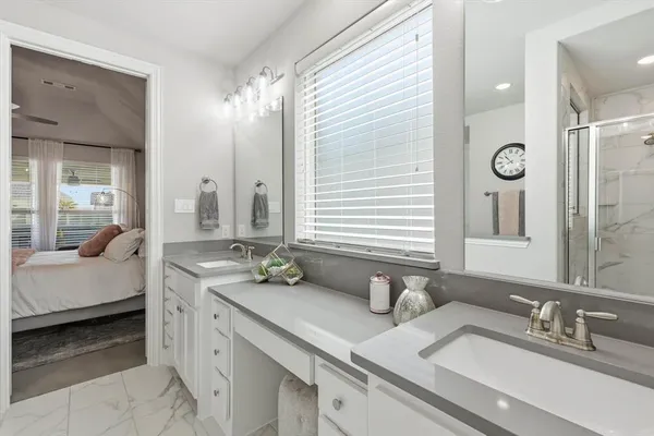 a bathroom with double vanity sinks and a mirror