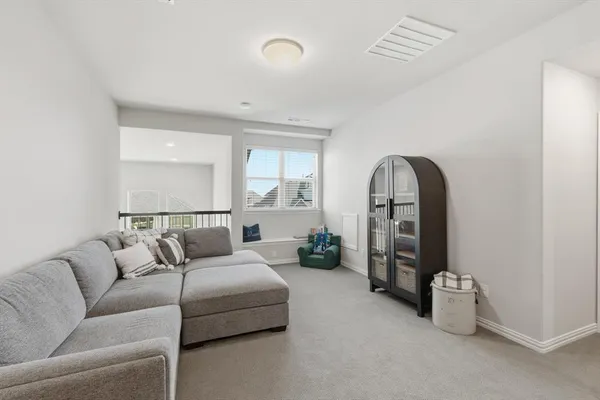 a living room with furniture and a mirror