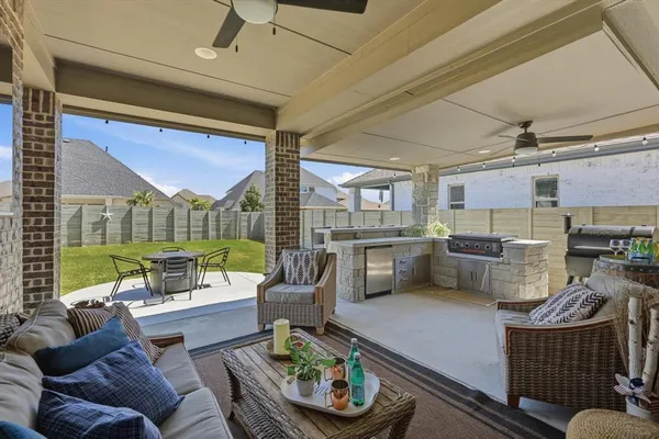 a living room with furniture and a floor to ceiling window